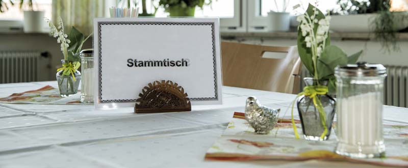 Dieses Foto zeigt ein Stammtisch-Schild auf einem schön gedeckten Tisch